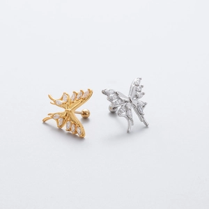 Macro detail of high-quality zircon butterfly stud earrings in gold and silver finish