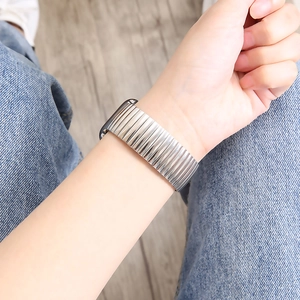 Polished stainless steel stretch watch band worn on wrist with elastic metal design