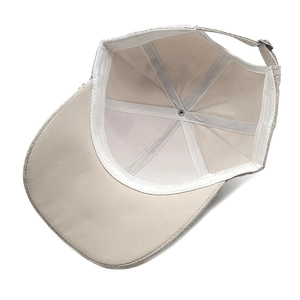 Internal view of beige suede baseball cap with reinforced seams and metal adjustment buckle