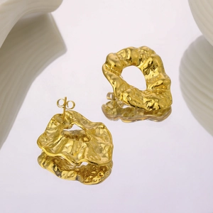 Modern 18K gold plated stainless steel earrings with irregular lava design on a mirror