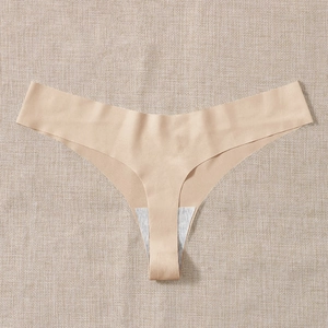 Seamless nude thong for women, high elasticity fitness underwear on beige linen background