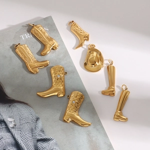 Golden titanium steel boot and hat charms set on a magazine background for jewelry making