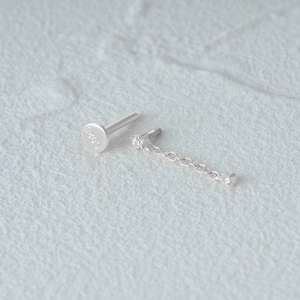 Close-up of S925 hallmark on silver cartilage piercing stud with heart chain detail