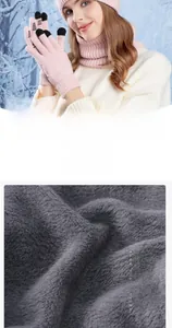 Detailed view of pink knitted winter set featuring warm hat, scarf and touchscreen gloves