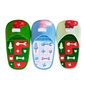 Three Christmas-themed sniffing pet slippers in blue and green with festive patterns