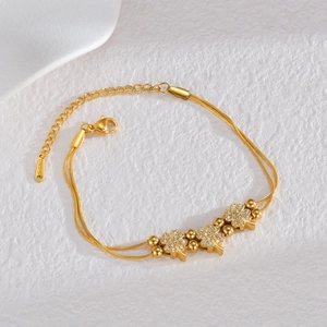 Double-layer gold clover bracelet with sparkling zircons and delicate metal beads