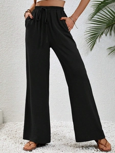 High-waisted black wide-leg trousers featuring drawstring waist and practical side pockets
