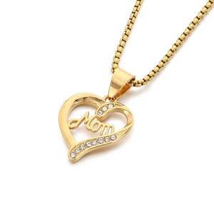 Golden heart pendant necklace with Mom script and crystal stones on white background