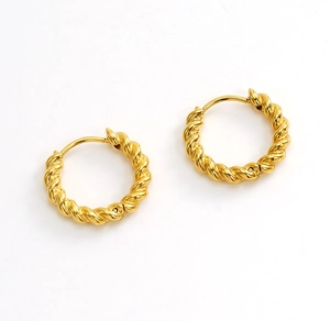 Macro detail of gold plated hoop earrings with spiral twist texture and secure clasp closure