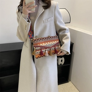 Detailed view of bohemian crossbody bag with colorful tassels and wide jacquard strap