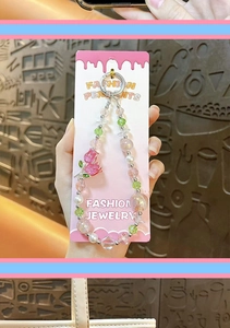 Detailed close-up of a pink tulip beaded phone charm with delicate sparkling crystal beads