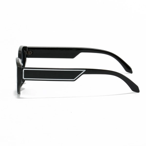 Vintage oval black sunglasses with thick geometric patterned temples and cat-eye frames
