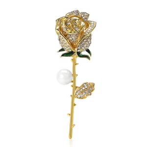 Elegant gold rose brooch with sparkling crystals, green enamel, and a white pearl accent