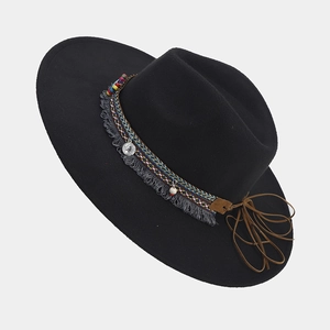Detail of ethnic style hat band with colorful beads, tassels and vintage coin pendant