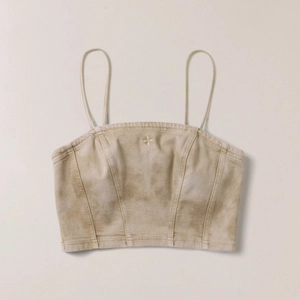 Detailed view of khaki denim crop top with heavy stitching and distressed texture