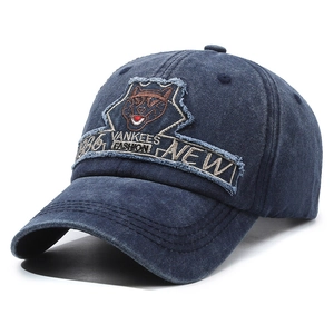 Vintage washed navy blue denim baseball cap with distressed embroidered animal patch