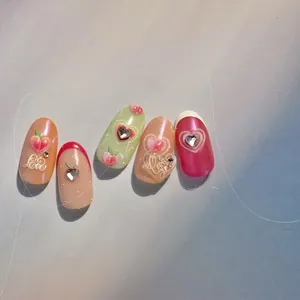 Detail of 3D peach nail art set with cat eye finish and heart relief charms