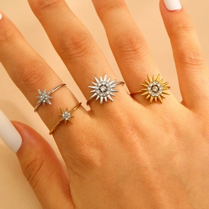 Set of four adjustable sunburst and starburst rings with sparkling pavé cubic zirconia