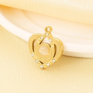 Golden heart crown pendant with white opal and small diamonds on beige silk fabric