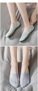 Detail of light green and purple lace cotton invisible socks showing breathable mesh texture