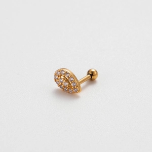 Macro detail of gold teardrop cartilage stud with cubic zirconia and screw back ball
