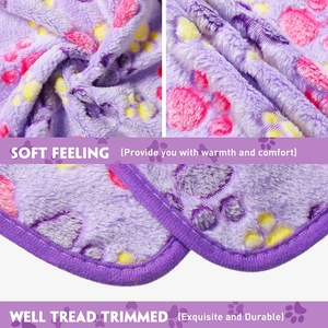 Detail of purple coral fleece pet blanket with paw prints and reinforced stitching