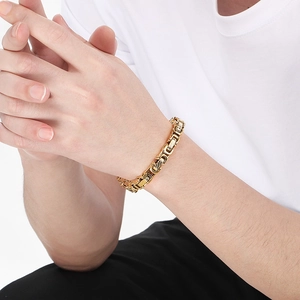 Detail of a men's gold Byzantine bracelet with twill design on a model's wrist