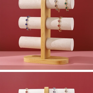 Detailed view of 3-tier bamboo jewelry display stand with soft beige velvet rolls