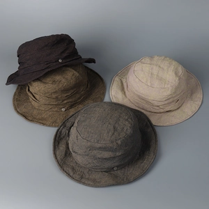 Selection of washed linen bucket hats in four earthy colors showing natural texture