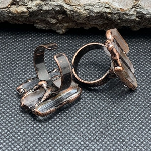 Detailed view of vintage bronze-plated rings featuring natural raw white crystals