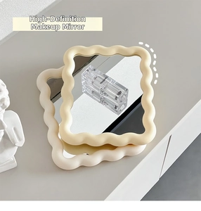 Detail of cream wave-shaped desktop makeup mirrors in beige and white minimalist plastic