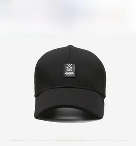 Detail of black golf baseball cap featuring waffle knit fabric and square logo patch
