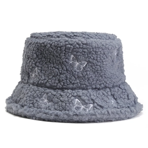 Blue sherpa fleece bucket hat with white butterfly embroidery for winter warmth