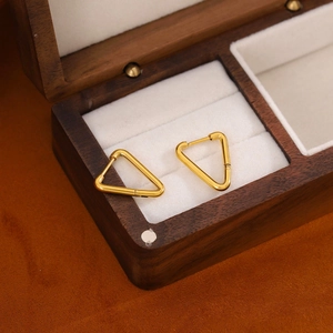 Minimalist 18K gold triangle earrings made of stainless steel on jewelry box