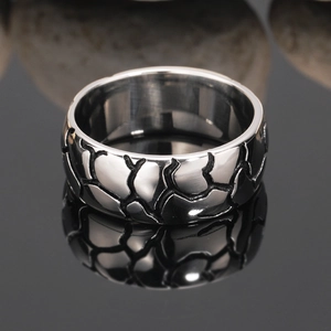 Men's punk titanium steel ring with black crack patterns on dark reflective surface