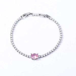 Detail showing a silver tennis bracelet with square white zircons and a pink oval stone