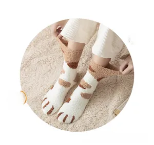 Close-up of thick coral fleece cat paw socks with cute 3D toe details in creamy white