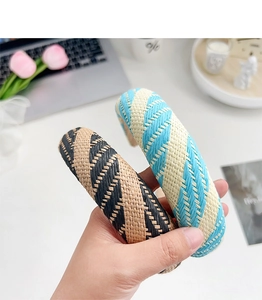 Detail of woven candy color headbands showing the textured blue, black and beige patterns