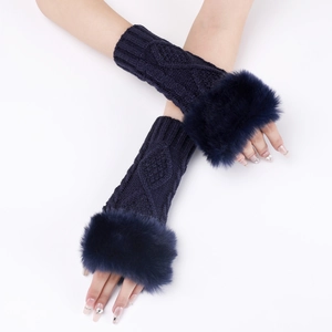 Close-up of cable knit fingerless gloves in dark blue with faux fur trim detailing