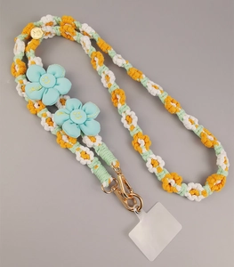 Detail of hand-woven orange and white flower phone lanyard with golden metal clasp