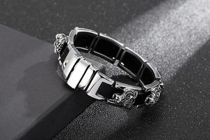 Macro detail of silver stainless steel tiger head charm on a braided bracelet
