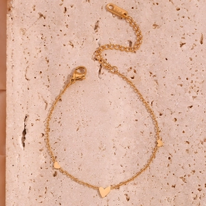 Detail shot of a 18K gold plated stainless steel chain bracelet with heart pendants