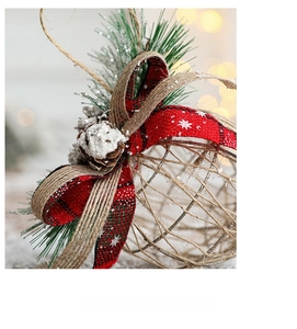 Close-up of Christmas ball with red plaid bow, pine cones and rustic rattan textures