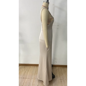 Detail of champagne sequin bodice and sleek satin fabric on long party dress