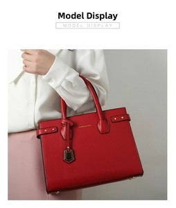 Detailed shot of red lychee grain leather tote bag with gold hardware and side buckle