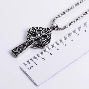 Gothic Celtic cross pendant in stainless steel with measurement scale on white background