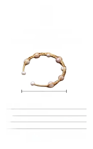 Detail of 18K gold plated wire wrapped bangle with natural freshwater baroque pearl
