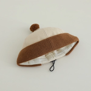 Detail of baby ribbed knit beanie featuring contrast colors and soft top pom-pom