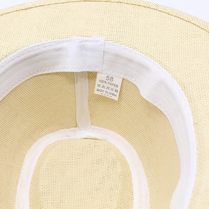 Detail view of the 100% paper material texture and sweatband of the Panama straw hat
