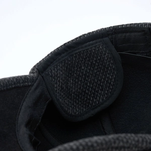 Macro shot of thick fleece lining and durable stitching on a warm elderly winter cap